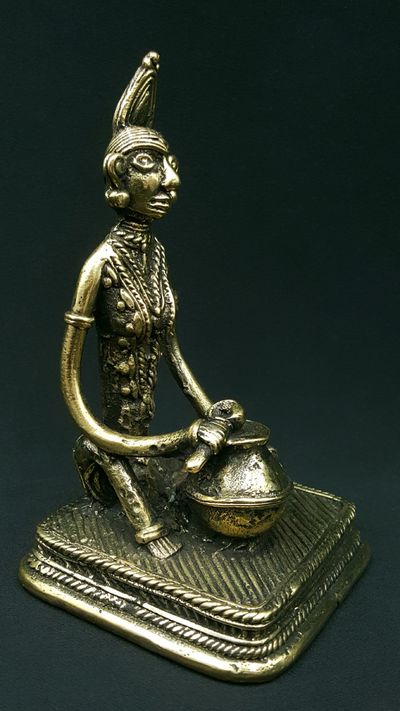 Woman sitting in front of her jar statue 